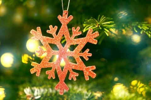 Red snow flake in a christmas tree with neon colors Stock Photos