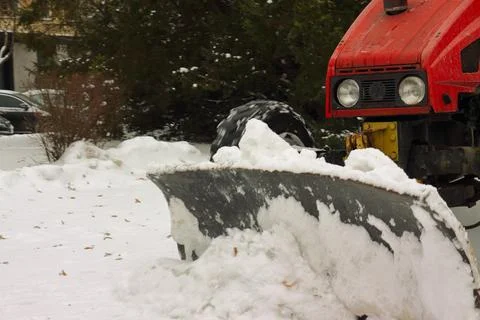 Red Snow Plow Blade Clearing Fresh Snowfall Outdoors Stock-Fotos
