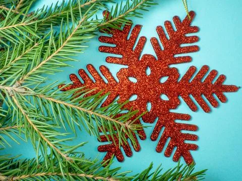 Red snowflake on a blue background. New Year card, decoration Stock Photos