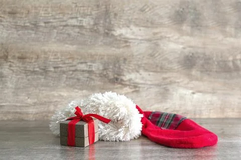 Red sock with present gift box on wooden table with copy space. christmas d.. Stock Photos