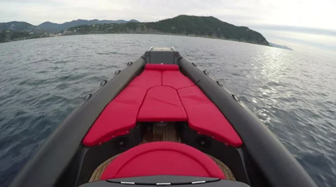Red sofa on the bow of a rubber boat  Stock Footage 58656904