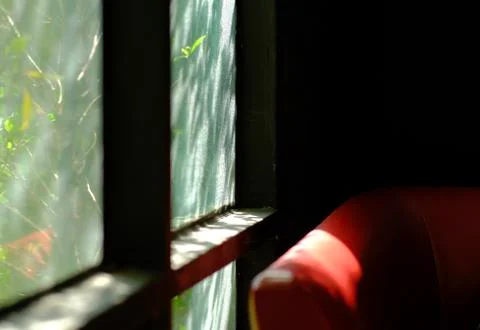 Red sofa with sunlight coming from the window. Stock-Fotos