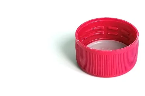 Red soft drink bottle cap on white Stock Photos