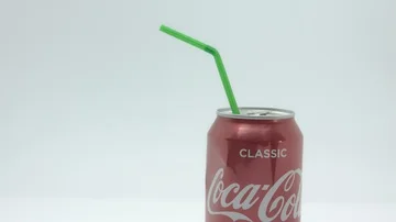 Red soft drinks can and straw, tilt shot Stock Footage 85854928