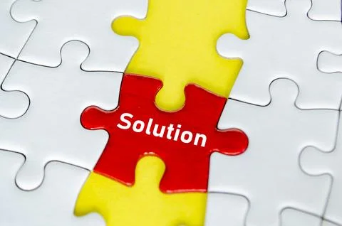 Red solution puzzle piece centered vertically between yellow puzzle section.. Foto stock