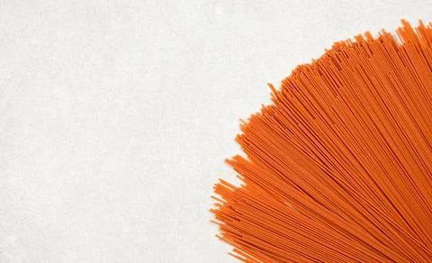 Red spaghetti on gray background with copy space Stock Photos