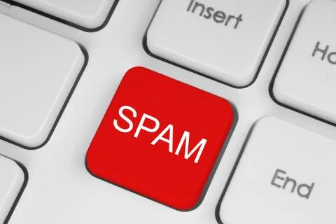Red spam button on white keyboard .. Stock Photos