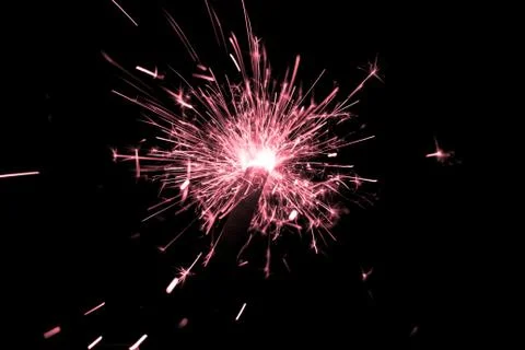 Red sparkler countdown on fire with spread of glitter sparks. Luxury entertai Stock Photos
