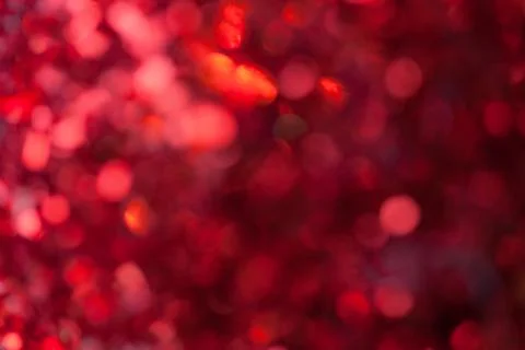 Red sparkling background from small sequins, closeup. Brilliant backdrop Stock Photos
