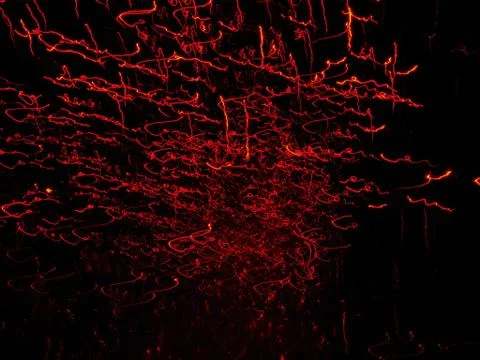 Red sparkling lights on dark backdrop Stock Photos
