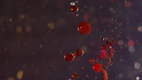 Red sparkling liquid bubbles moving on a clear bokeh background texture Stock-Footage 118287856
