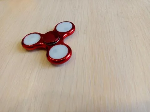 Red spinner on a light table 写真素材