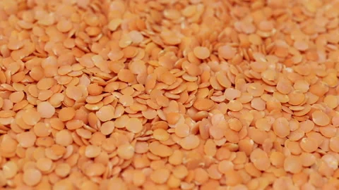Red split lentil pulses slowly rotating, macro closeup Stock Footage 132644296