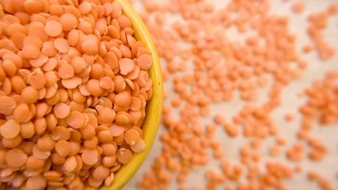 Red Split Lentils Masoor Dal in Yellow Bowl Healthy Closeup Flat lay Top View Stock Photos