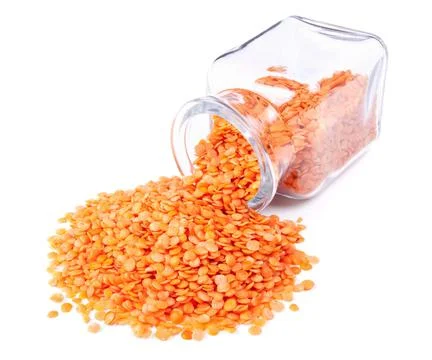 Red split lentils scattered on a white background Stock Photos