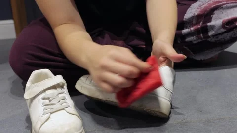 Red sponge cleaning white casual shoe Stock-Footage 337955269