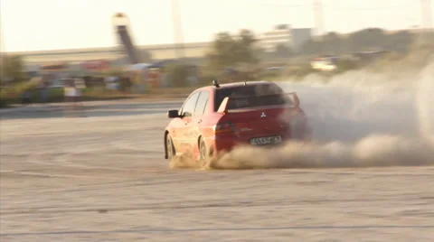 Red sports car drifting on sand Stock Footage