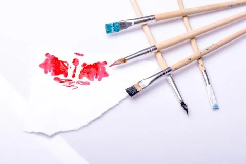 Red spot and ordered paintbrushes Stock Photos