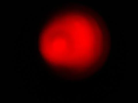 Red spot on a black background Stock Photos