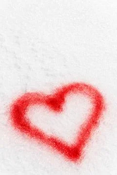 Red sprayed heart in the snow Photos