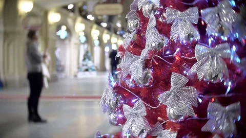 Red spruce in silver bows. New Year's and abstract blurred shopping mall 스톡 동영상 70655664