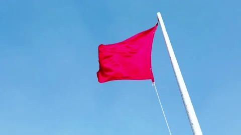 Red square flag in the wind Stock Footage 146076291