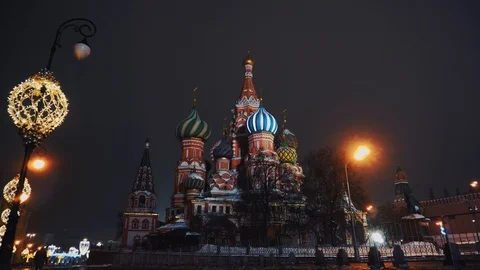 Red Square, a lonely guy walks past the Kremlin and Basil Church, winter, night Stock Footage 103185345