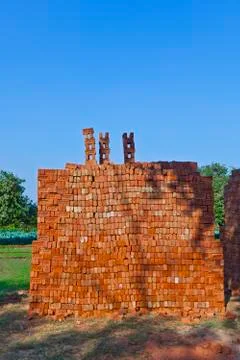 Red stapled bricks give a harmonic pattern in the sun Stock Photos