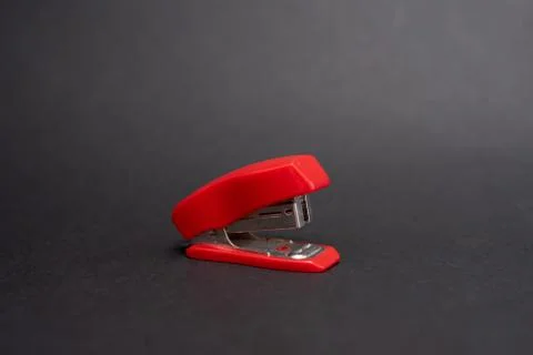 Red stapler on a black background Stock Photos