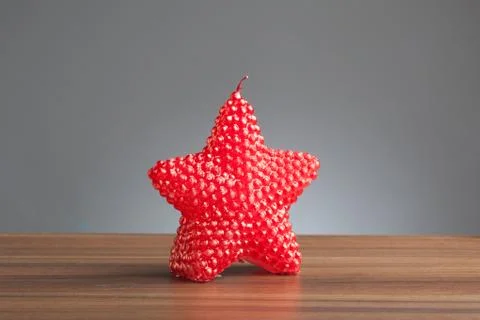 Red star shape candle on table Stock Photos