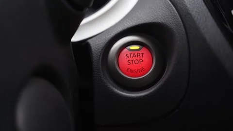Red start stop engine button close up Video stock 334720139