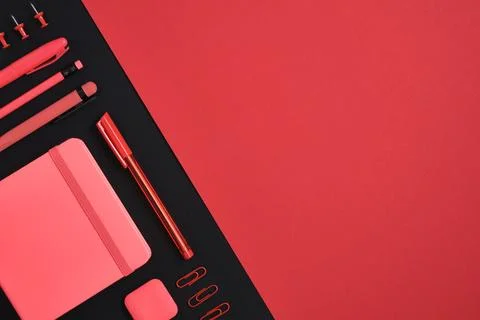 Red stationery set of pencil, pen, marker, clips, notebook, eraser on black a Stock Photos