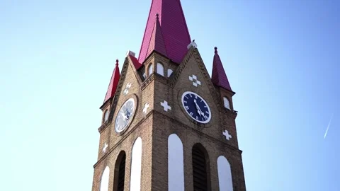 Red Steeple Church Tower with Clock against Blue Sky Stock Footage 332269669