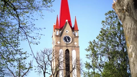 Red Steeple Church Tower with Clock against Blue Sky Stock Footage 332269674