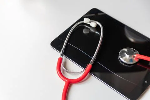 Red stethoscope on black tablet device shows cloud data security digital doctors Stock Photos