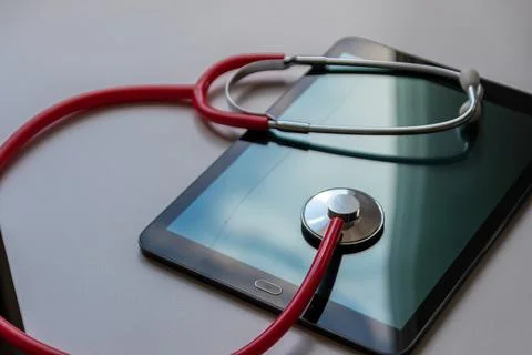 Red stethoscope on black tablet device shows cloud data security digital doctors Foto stock