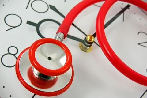 Red stethoscope on the clock Stock Photos