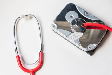 Red stethoscope with internal hard disk drive hdd contains health record Stock Photos