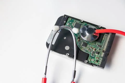 Red stethoscope with internal hard disk drive hdd contains health record Stock Photos