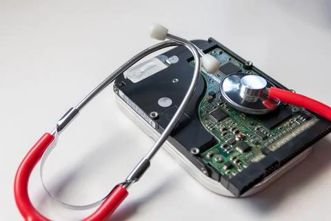 Red stethoscope with internal hard disk drive hdd contains health record Stock Photos