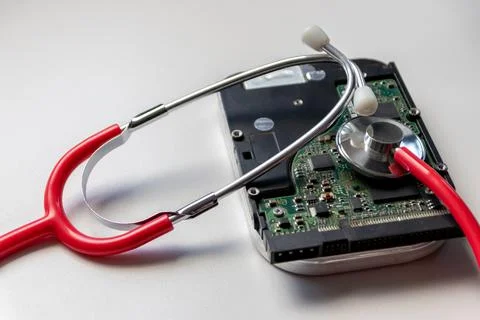 Red stethoscope with internal hard disk drive hdd contains health record Stock Photos