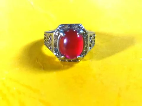 Red stone ring on a yellow background Stock Photos