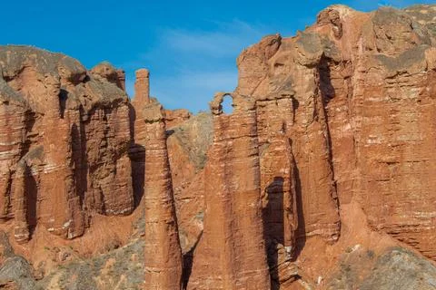 The red stone rock formations looking like sculptures at Binggou Danxia Sce.. Stock Photos