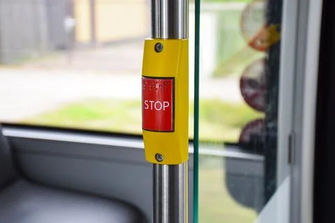 Red STOP button with braille on a yellow mount attached Stock Photos