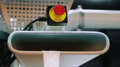 A red stop button is installed on industrial equipment that retracts polyethy Video stock 331861590
