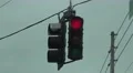 Red Stop Light Swinging In The Wind On Cloudy Day 4k or 4k+ Resolution