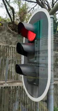 Red stop light with transparent reflection of city street Foto stock