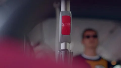 Red stop request button on bus pole with blurred passengers Stock Footage 347202957
