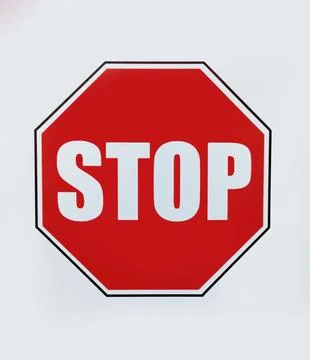 A red stop sign on a white background in close-up... Stock Illustration