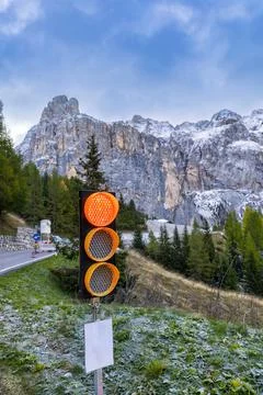 A red stop traffic light on a forest road in the mountains. Vertical photo. Stock Photos